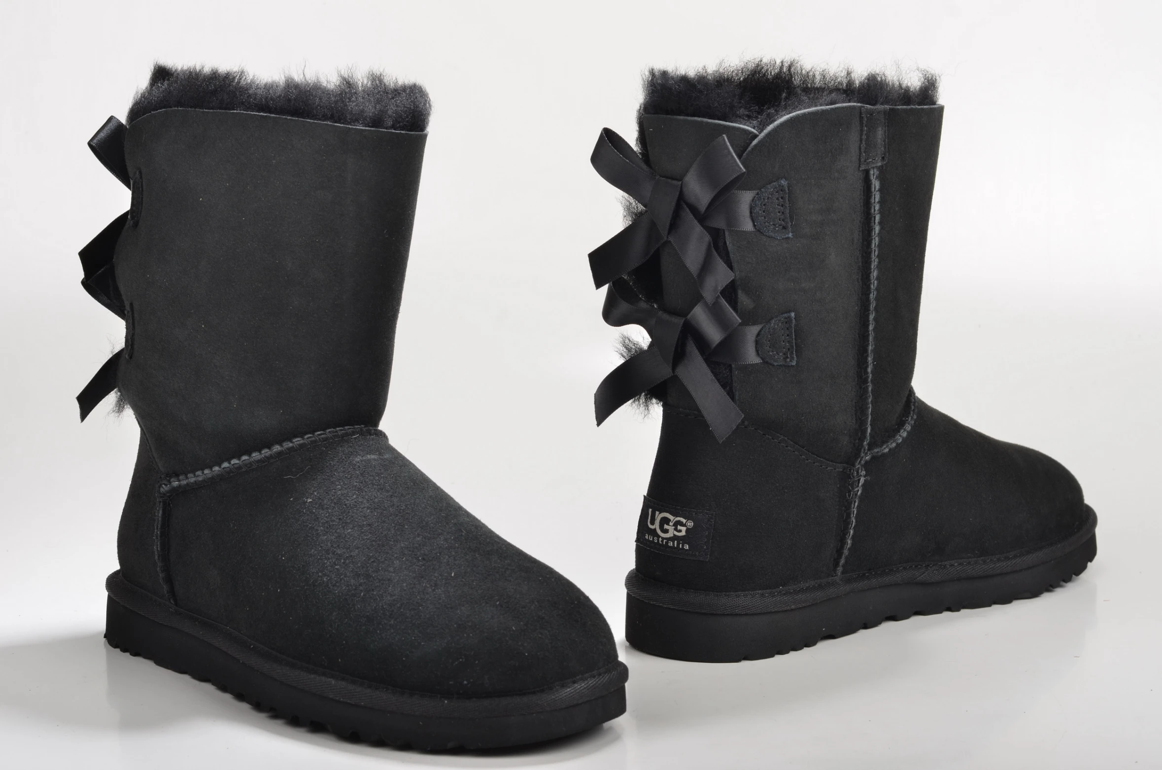 a pair of black sheep boots with ruffles