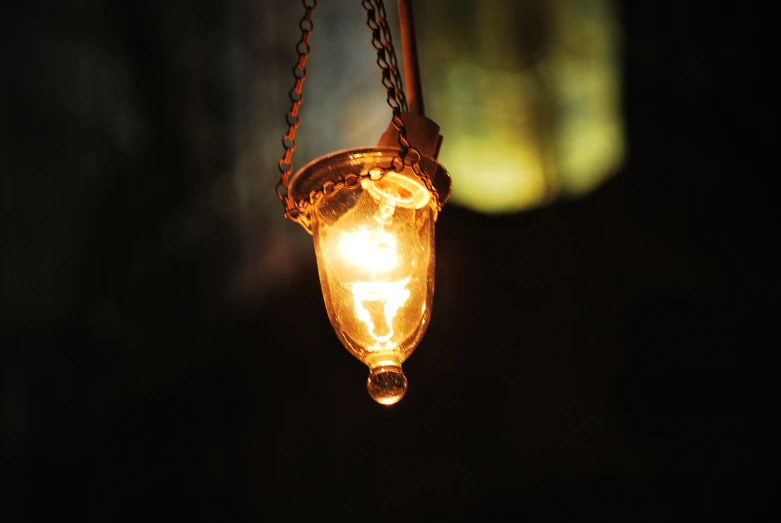 light bulb in the darkness hanging with chain