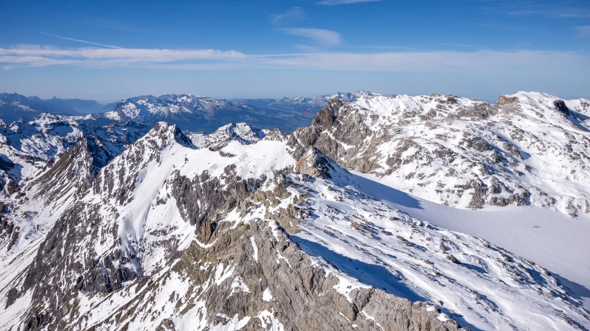 the view from the top of a large mountain in winter