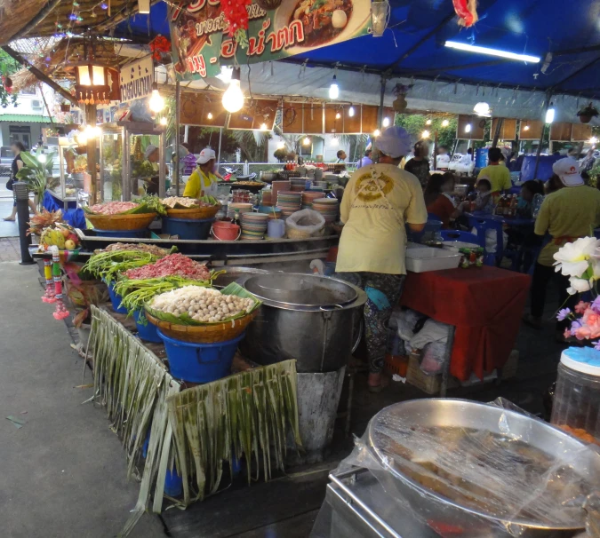 an outdoor food market with various items for sale