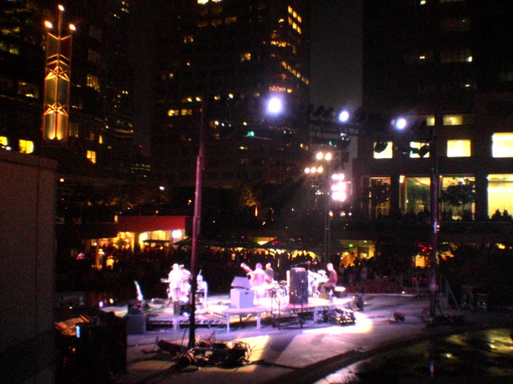 a nighttime scene in a city, with bright lights on the building