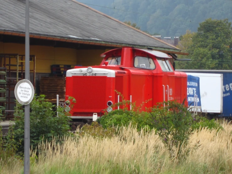 the old train engine is painted bright red and white