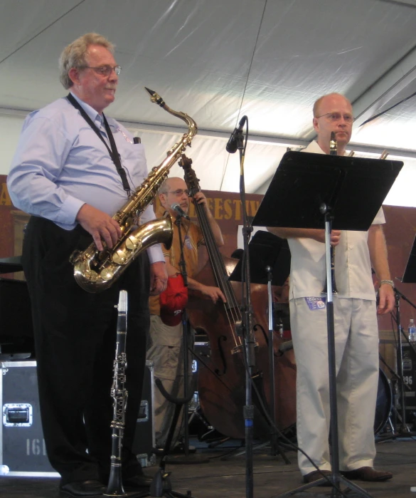 a band of men playing instruments under a tent