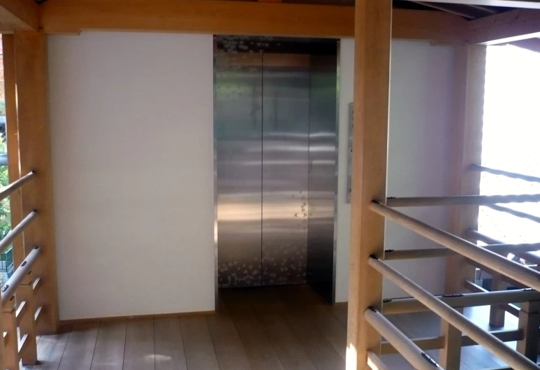 an elevator in the center of a wooden floor