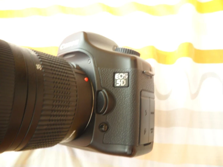 a camera and lens sitting next to each other