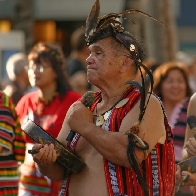 a man with two axes standing in front of other people