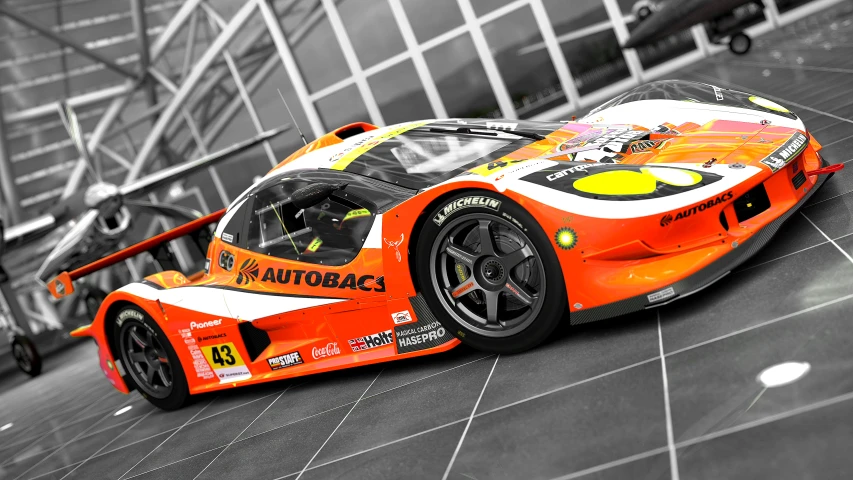 a orange race car driving on top of a hard ground