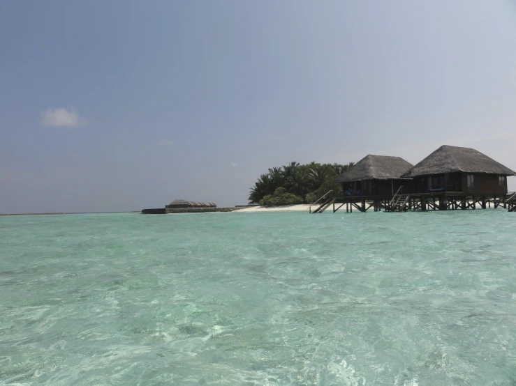 a couple of wooden houses that are sitting in the water