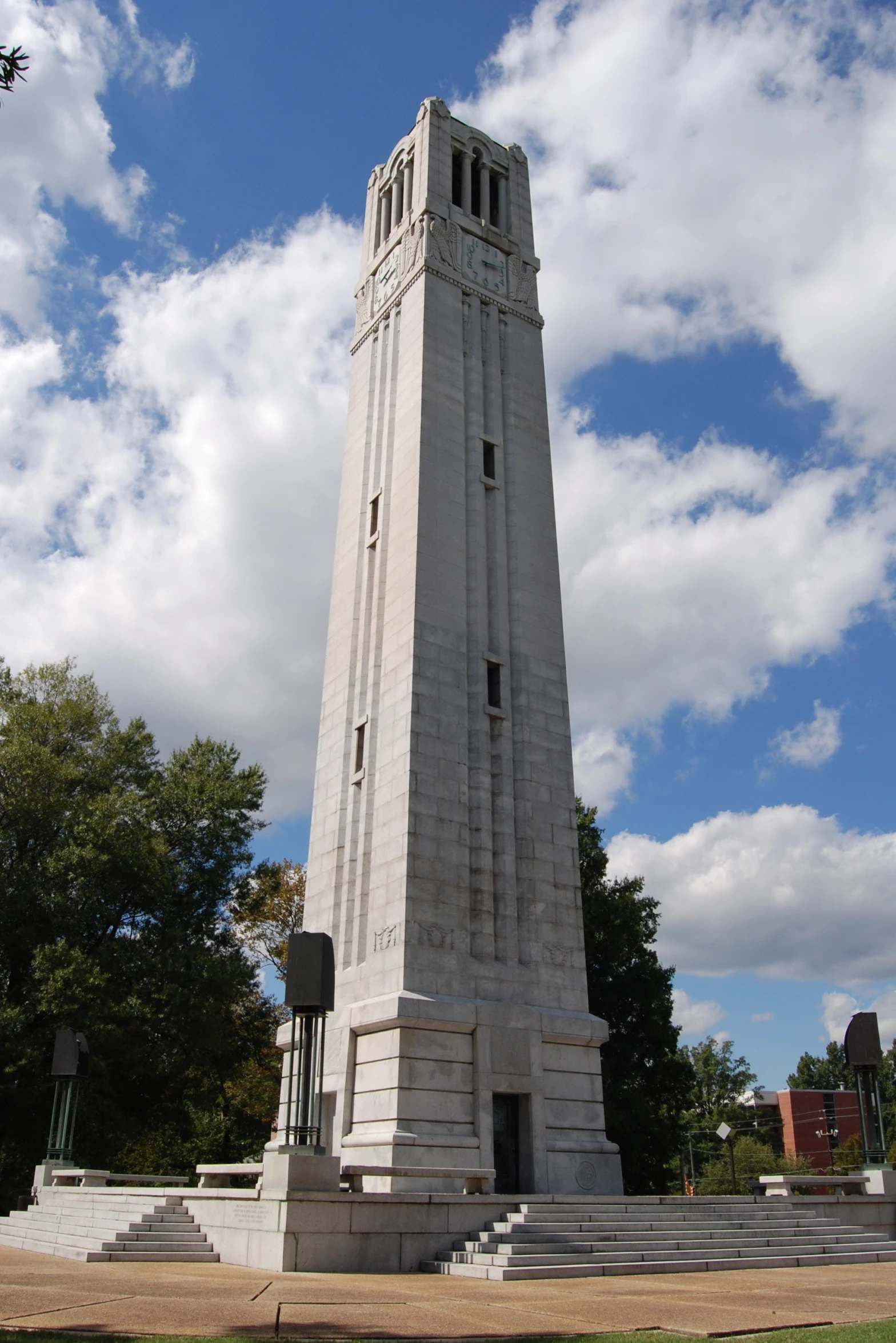 a tall clock tower towering over a city filled with trees