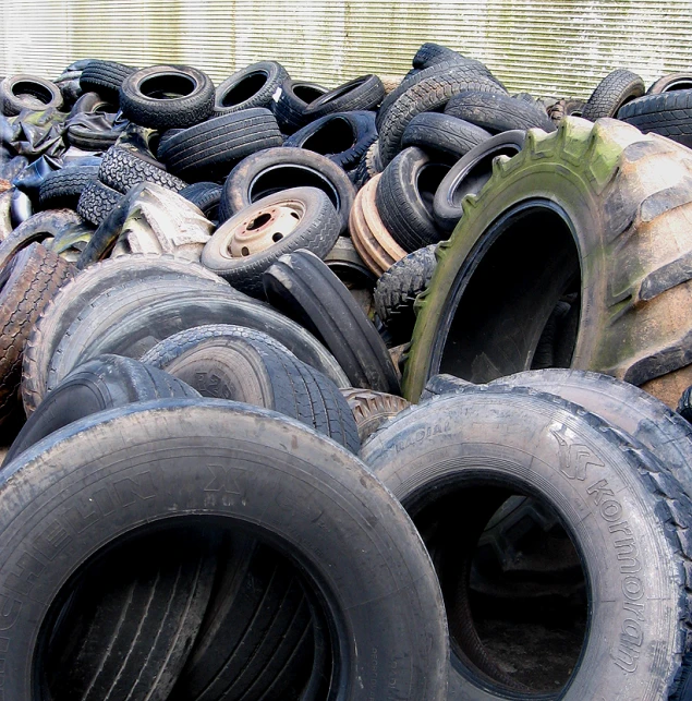 piles of old tires are displayed with green trims