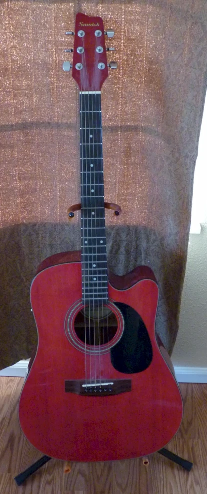 a guitar in a chair that is ready for display