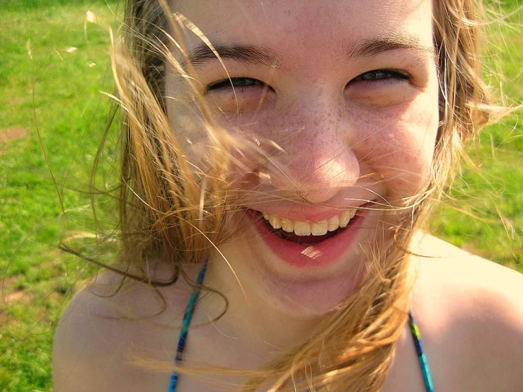 a girl wearing a bikini with long hair and blowing wind