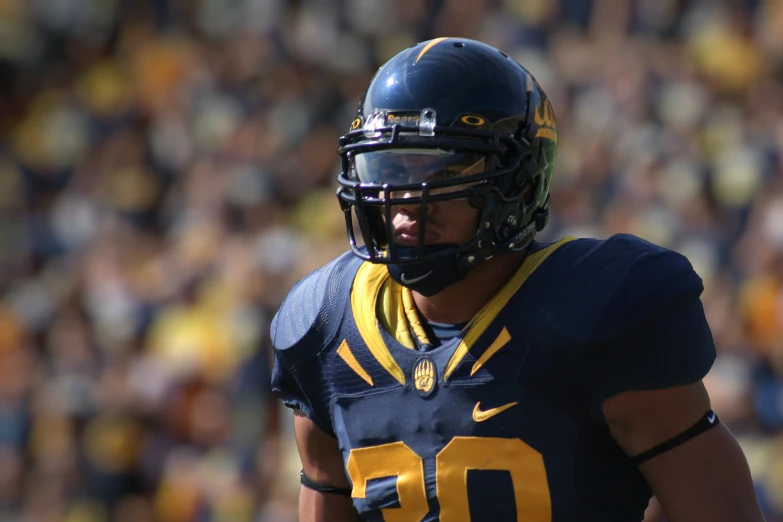 a man in uniform and helmet on a football field