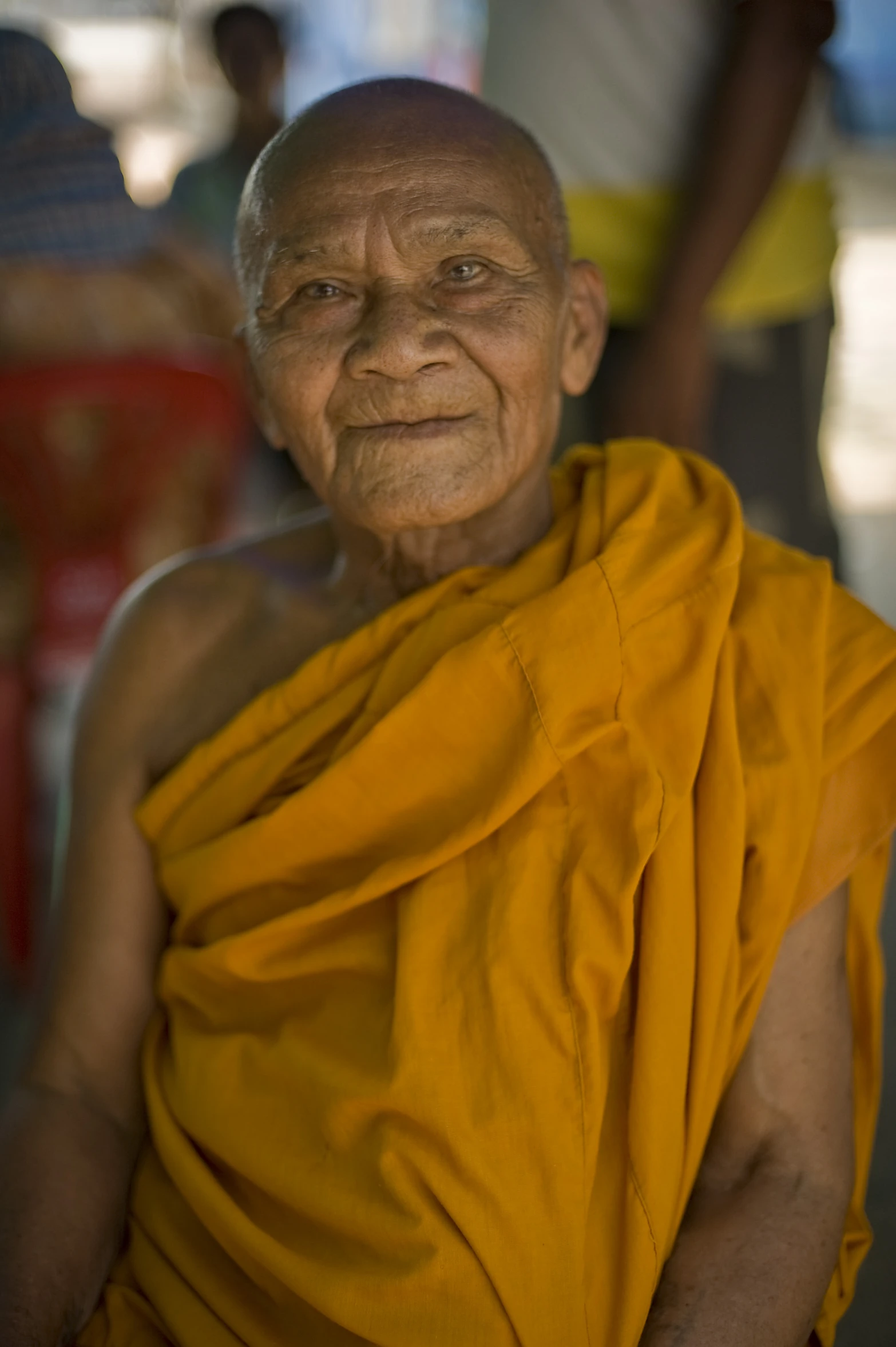 an old man with very large yellow robe on