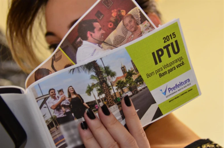 the woman is holding some pictures from her book