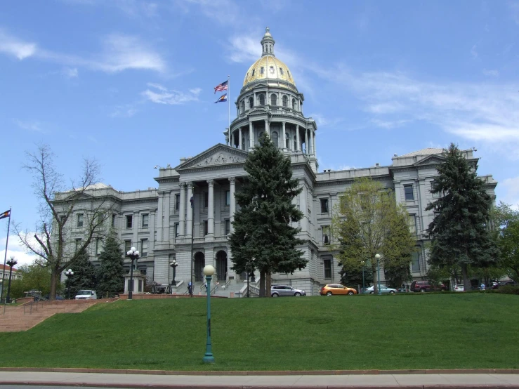 a tall building with a yellow dome and two towers