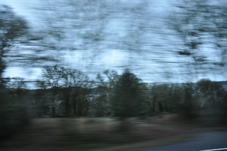 a blurry po of some trees and road