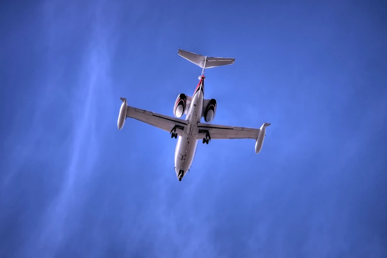 an air plane with four people flying in the sky