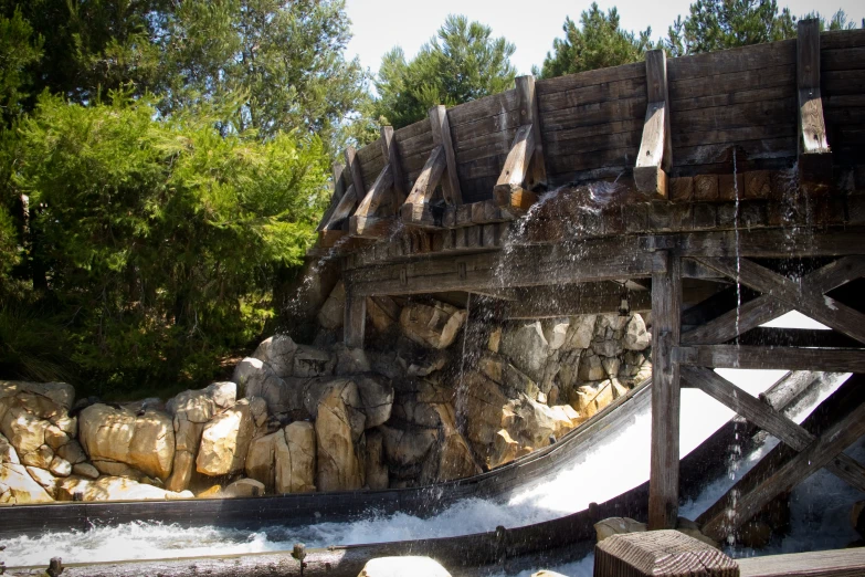 the water gushes from under the bridge over the water