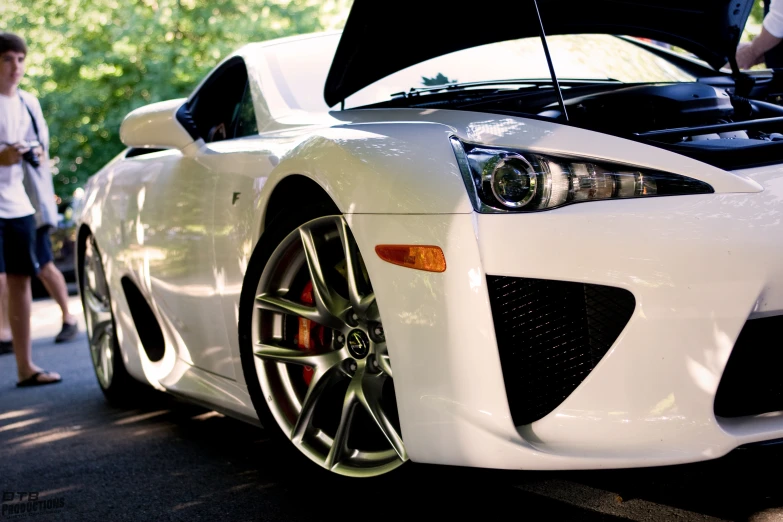 a white sports car parked on the street