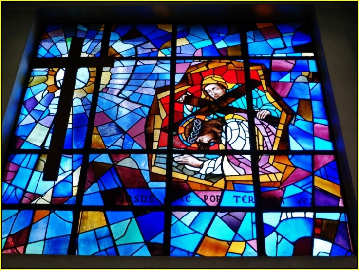 a large stained glass window showing jesus and mary