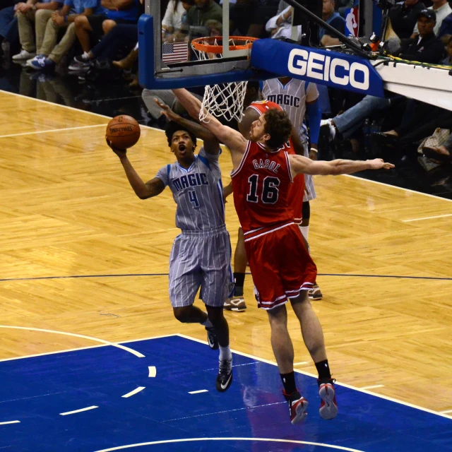 a basketball game being played on a blue court