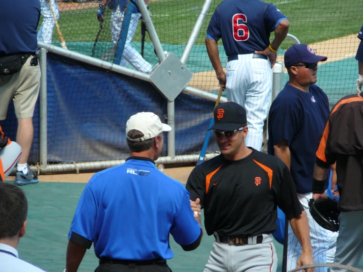 a man wearing baseball clothes walking on a field