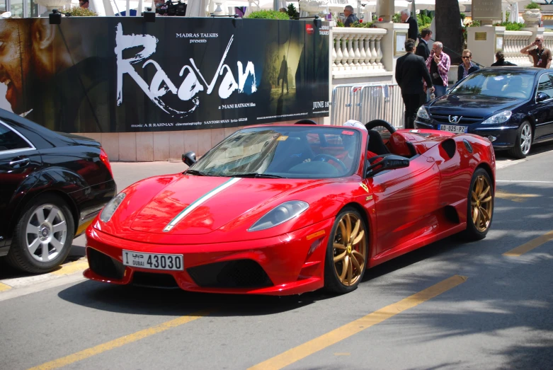 some cars on the road with people behind them