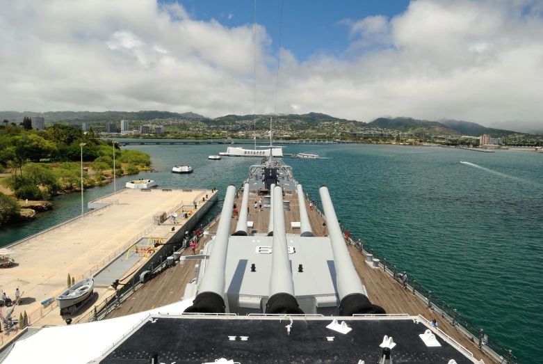 a naval boat is anchored on a large pier