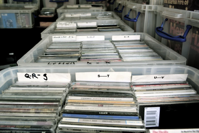 there are many stacks of records in bins