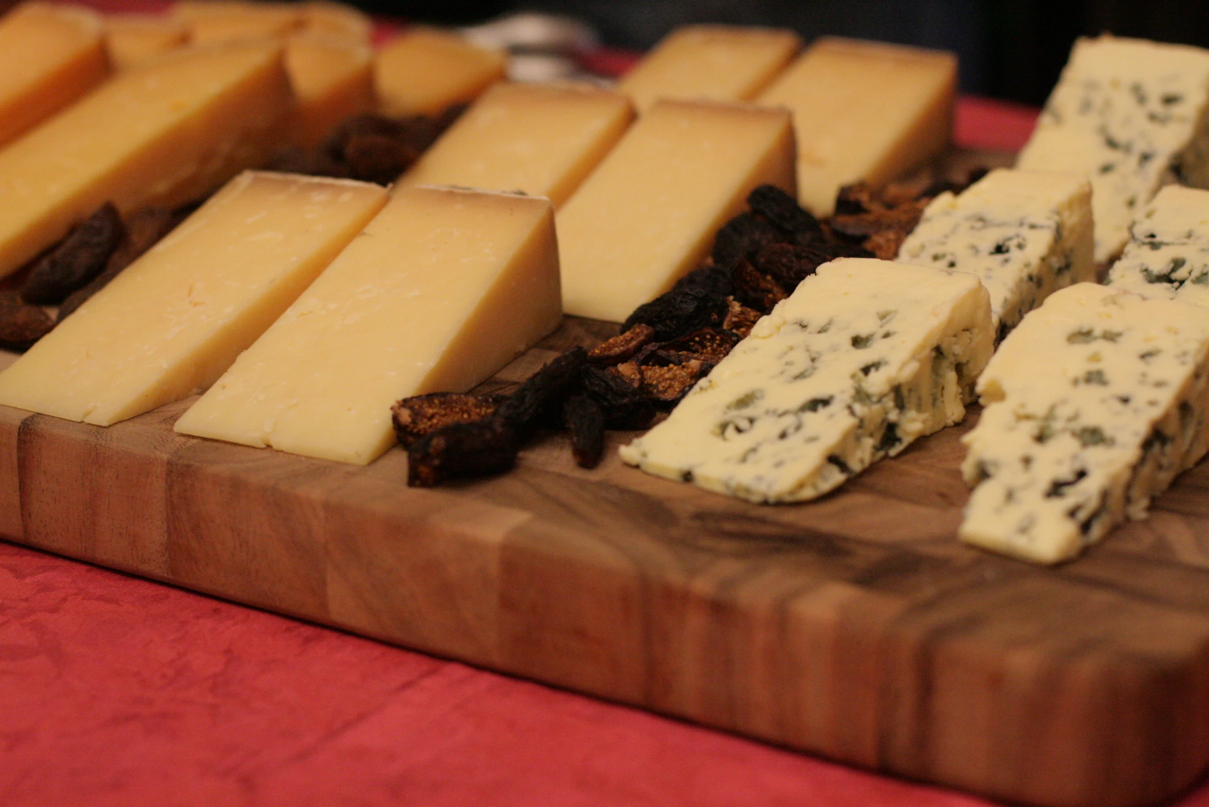 a tray of cheese is cut into squares