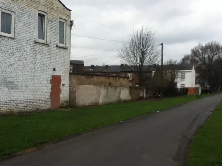 a brick building next to the road