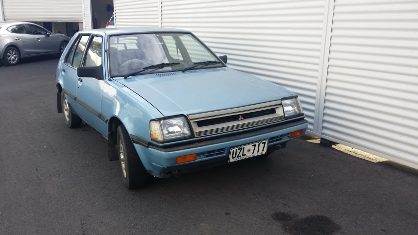 an image of a blue car parked in a driveway