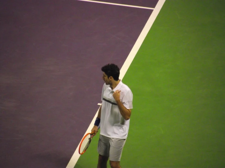 a male tennis player is at the baseline during a game