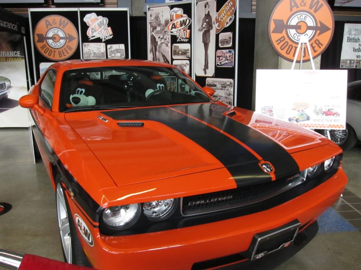 a large orange sports car with a black stripe