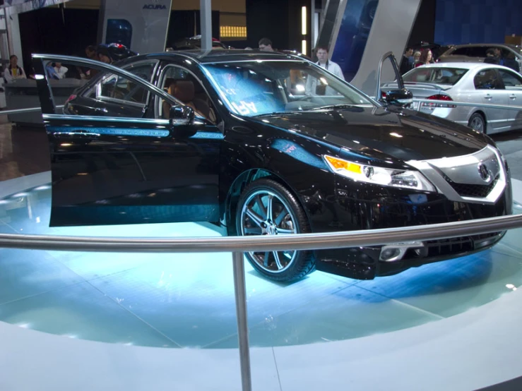 black colored car on display in a showroom