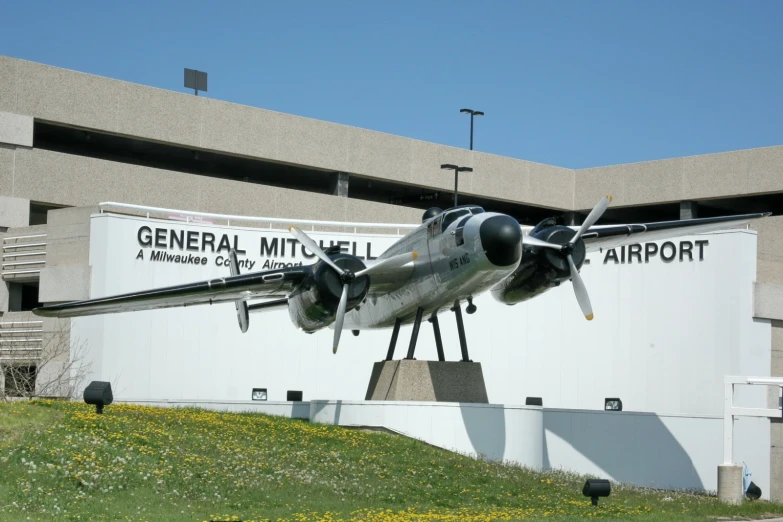 the large airplane is on display in front of the building