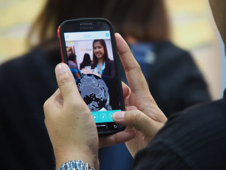 a person taking a picture with her cell phone