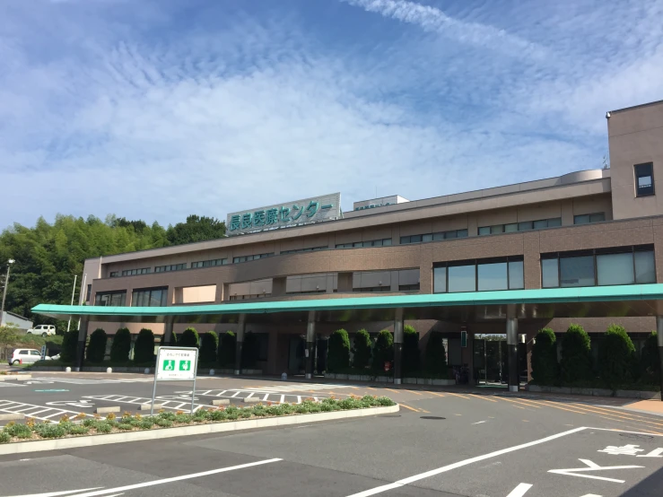 a view of an office building at the corner of a street