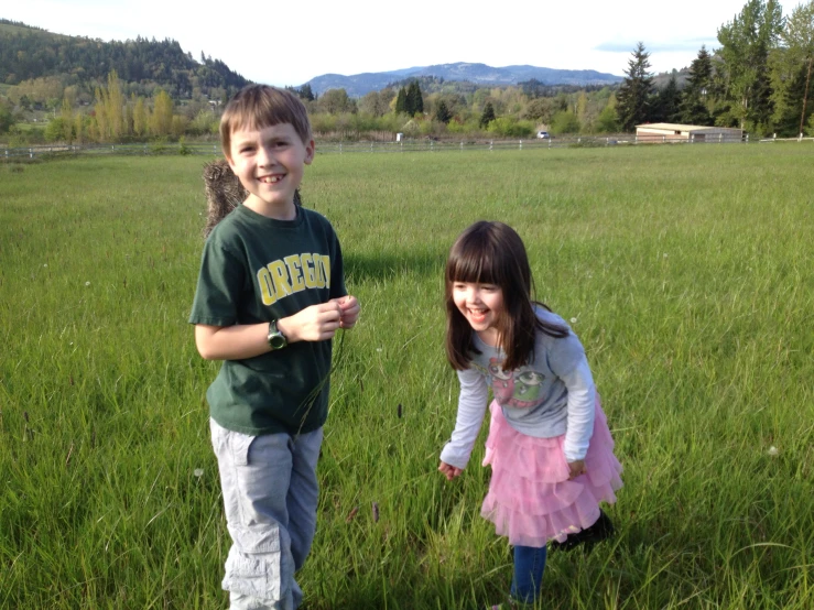 a boy and girl pose for the camera with their finger