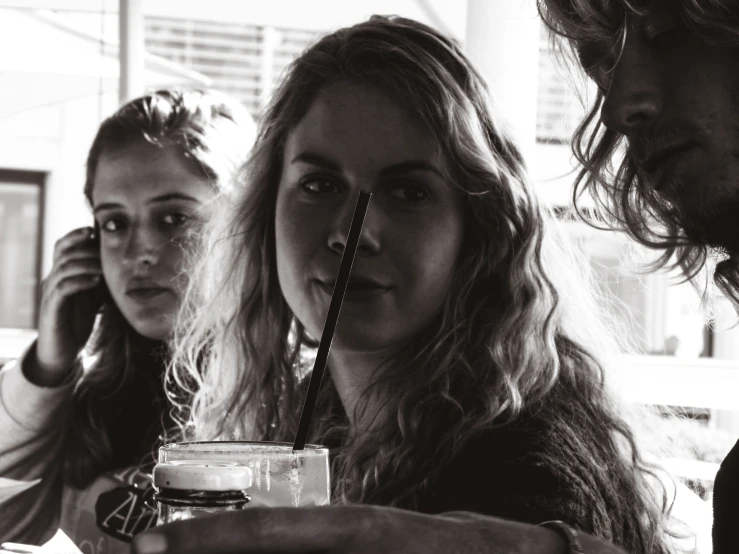 two ladies drinking from glasses in front of them