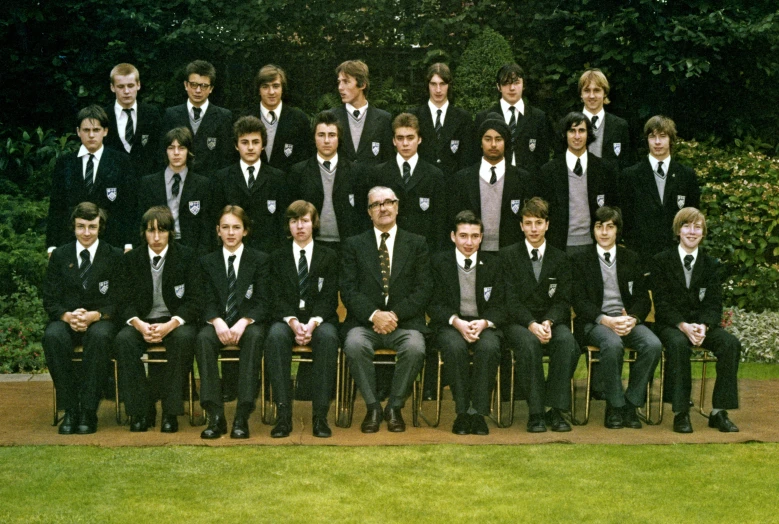 group of students dressed in business suits posing together