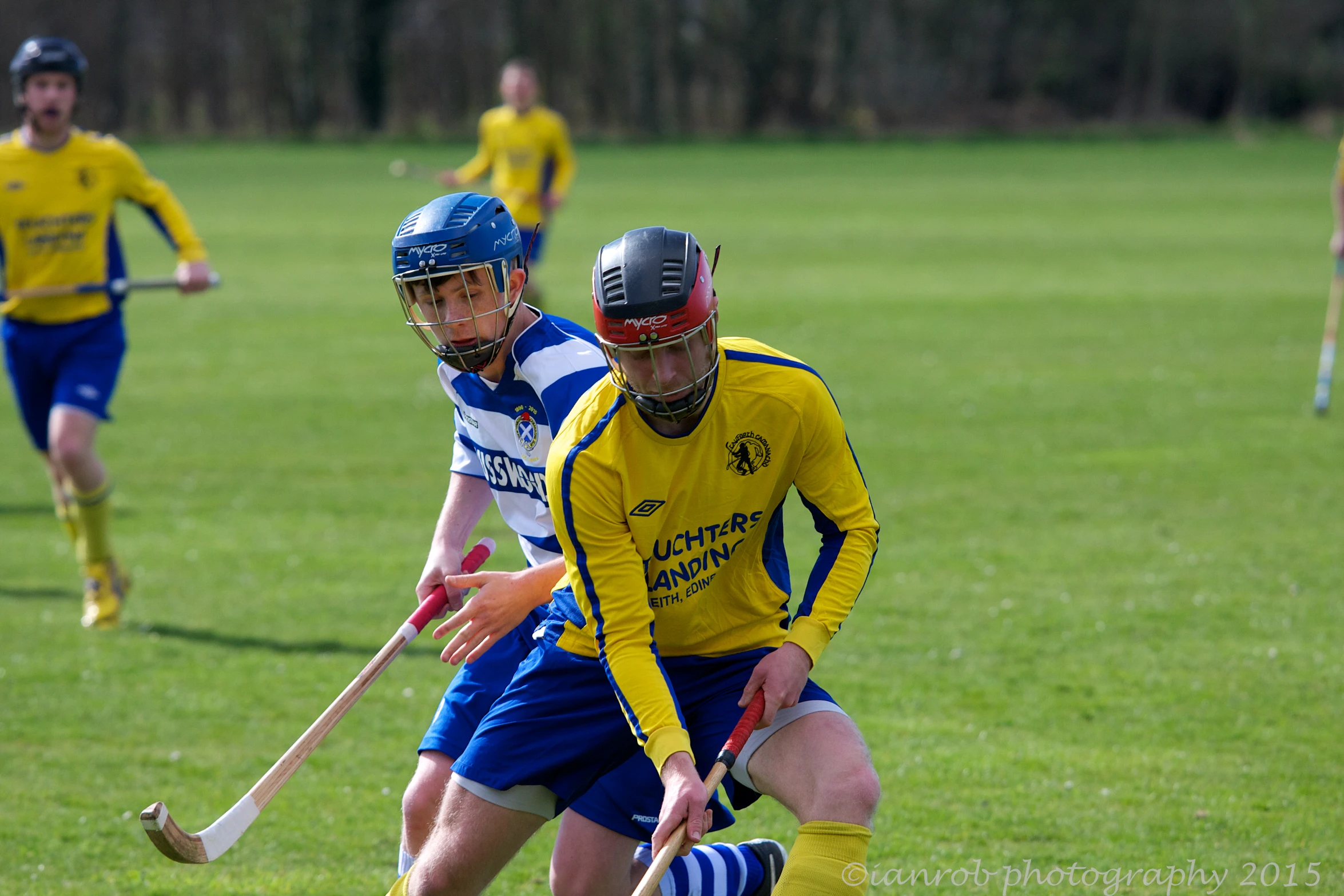 two opposing players playing a game of field hockey