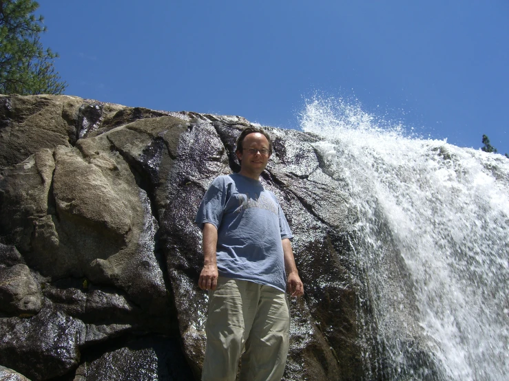 a man standing next to some large rocks