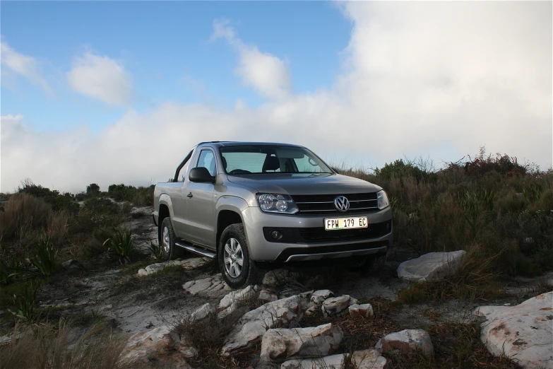 a grey volkswagen truck driving down a hill