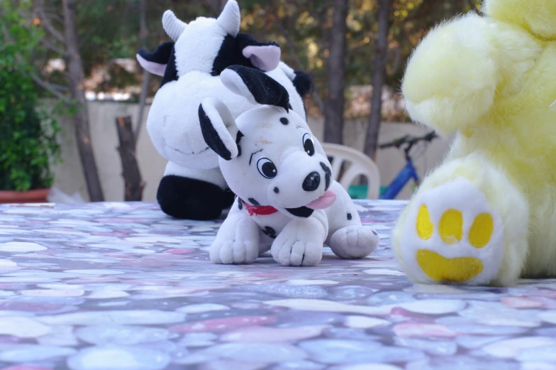 the stuffed dog and toy are on a table