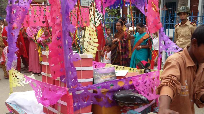 the crowd is watching a vendor set up her vendors stand