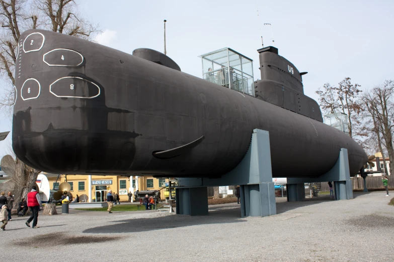 a big large black ship on display at a museum