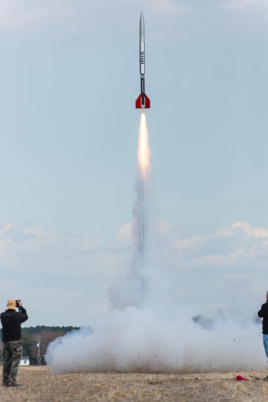 people watching the space launch from a hill