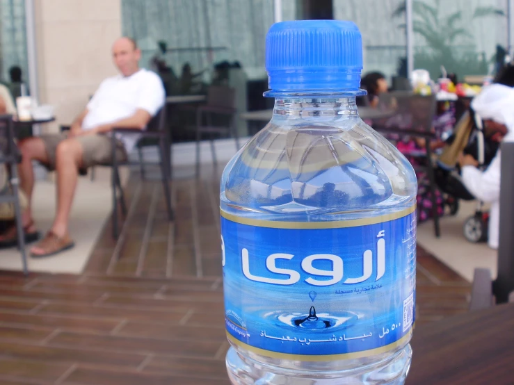 a blue bottle is sitting on a table